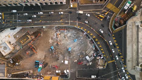 drone descends towards construction site as cars drive around detour to avoid work