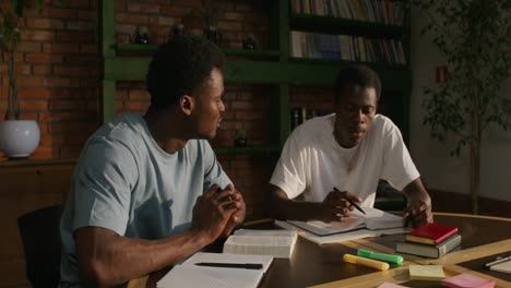 two men studying in a cafe