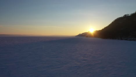 winter sunset over a frozen lake