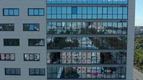 modern glass wall in the city, drone dolly in shot