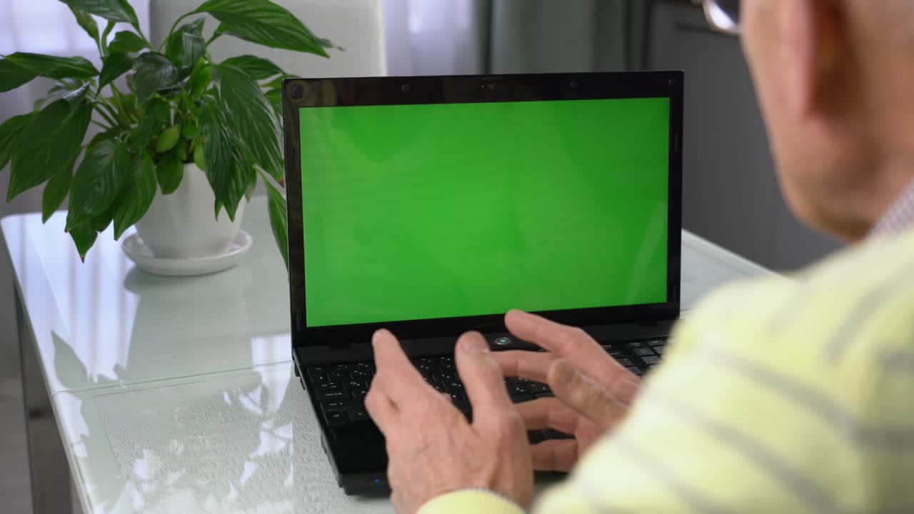 persona madura hablando en línea usando una computadora portátil con pantalla en blanco con
