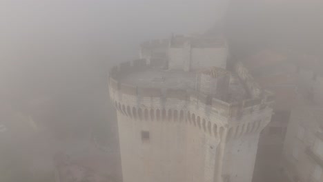 Vista-Aérea-A-Través-De-La-Niebla-En-La-Gira-Philippe-le-bel,-Una-Torre-Medieval-En-Villeneuve-lès-avignon,-Francia