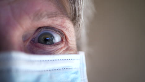 the eye of a terminally ill elderly woman medical patient looking shocked and scared in the hospital