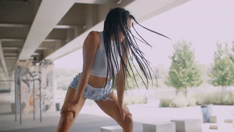 woman dancing under a bridge