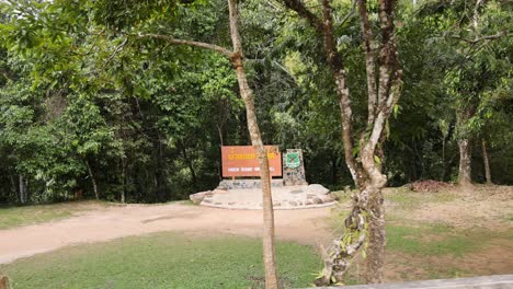 signboard approaching along a forest trail