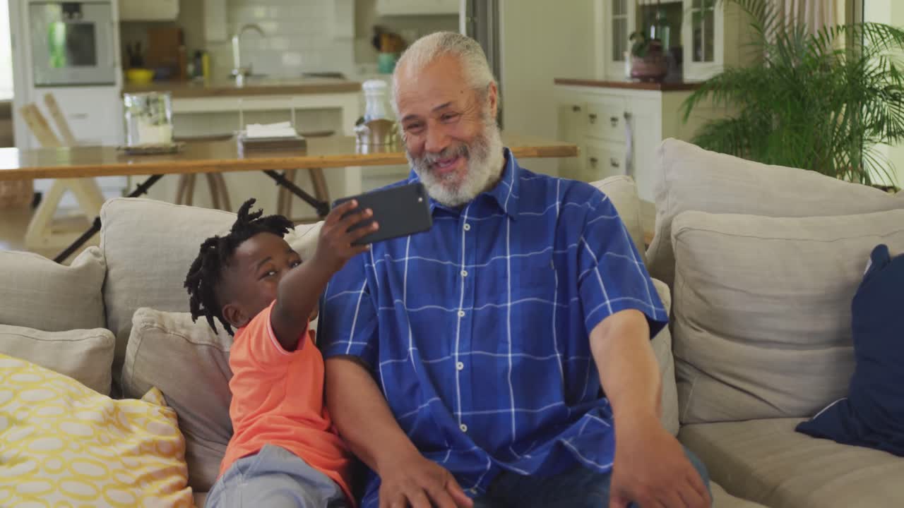 Grandfather and grandson using smartphone