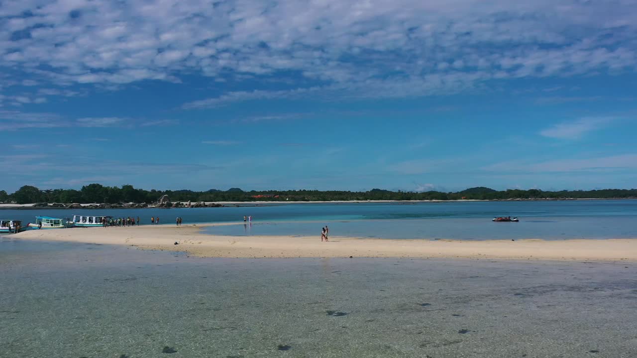 belitung의 열대 모래톱을 걷는 관광객