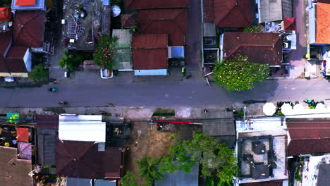 scooters driving on narrow street in residential neighborhood, canggu