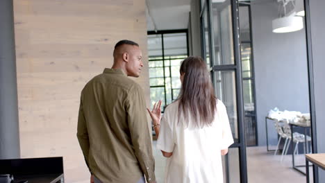business colleagues discussing work while walking through modern office space