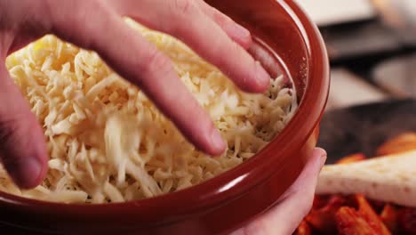 adding cheese to a dish