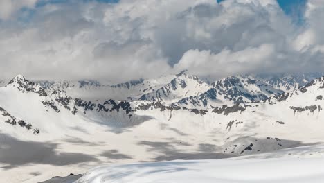 air flight through mountain clouds over beautiful snow-capped peaks of mountains and glaciers.