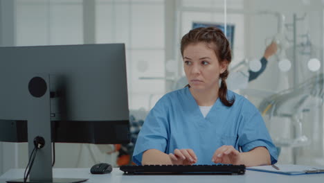 stomatological assistant typing on computer keyboard