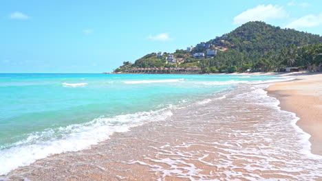 view of incoming waves along the beach leading to a seaside mountain