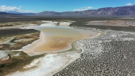 aerial view of strange california landscape, salt flats in desert valley on sunny day, drone shot