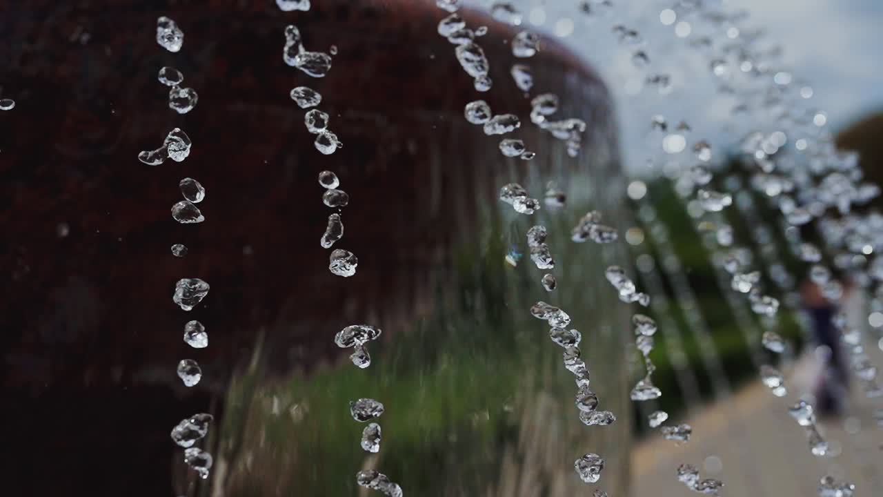 Fountain with dripping water. Close up outdoor view of public fountain with many small water jets