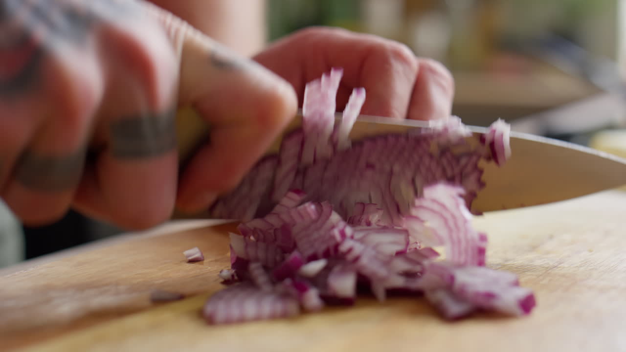Male Hands Chopping Red Onion