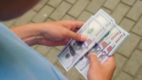 a man on the street is counting money 01