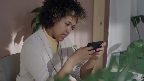 Woman using a smartphone in a home office