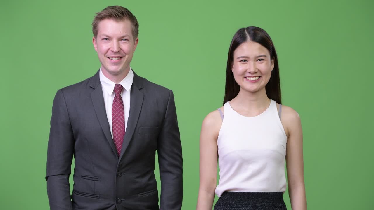 Happy multi-ethnic business couple smiling together