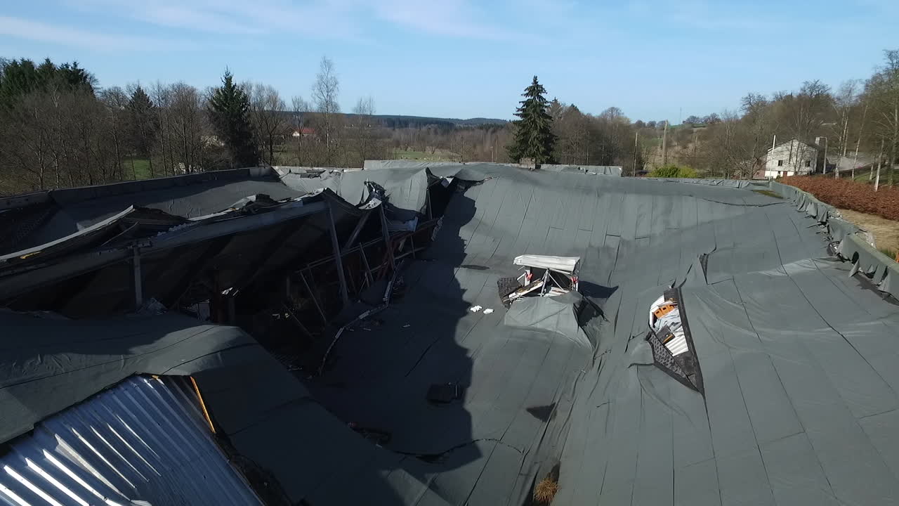 Aerial view of a collapsed roof of a bottling factory. Collapsed by excessive snow weight on the roof.