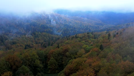 Dreamy-Aerial-View-Of-Mountain-In-Clouds