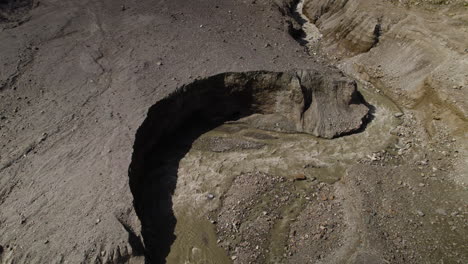 melting glacier lake stream, eastern alps glacier covered with moraine, austria, drone shot