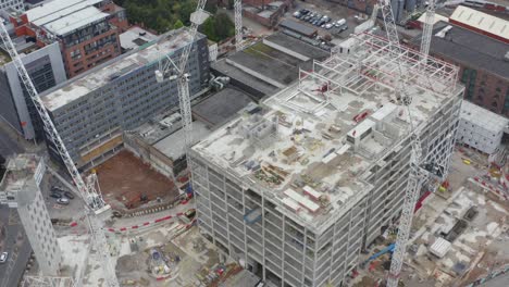 drone shot panning over construction cranes