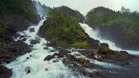 scenic latefossen twin waterfall, norway. idyllic cascade in scandinavia nature, lush green landscape.