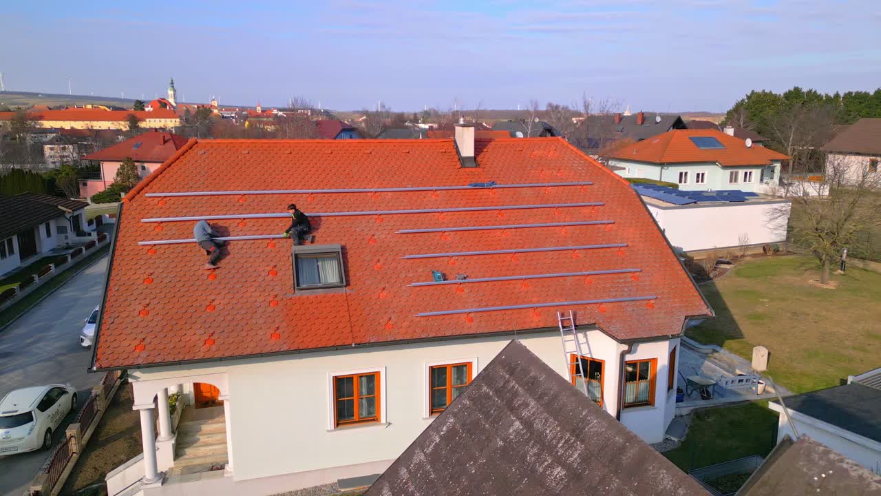 Men Putting Steel Railings On Roof For Installation Of Solar Panels. - aerial