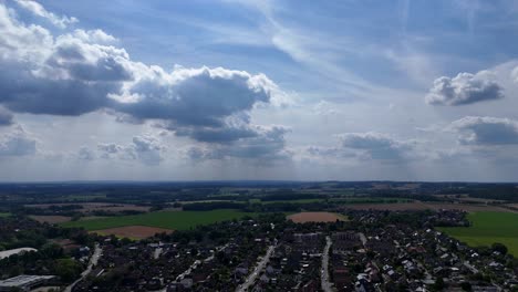 houses and homes of small american town. clouds at sky. sunny day in summer. aerial lateral wide shot. rural countrside farmland in usa. quiet suburb district