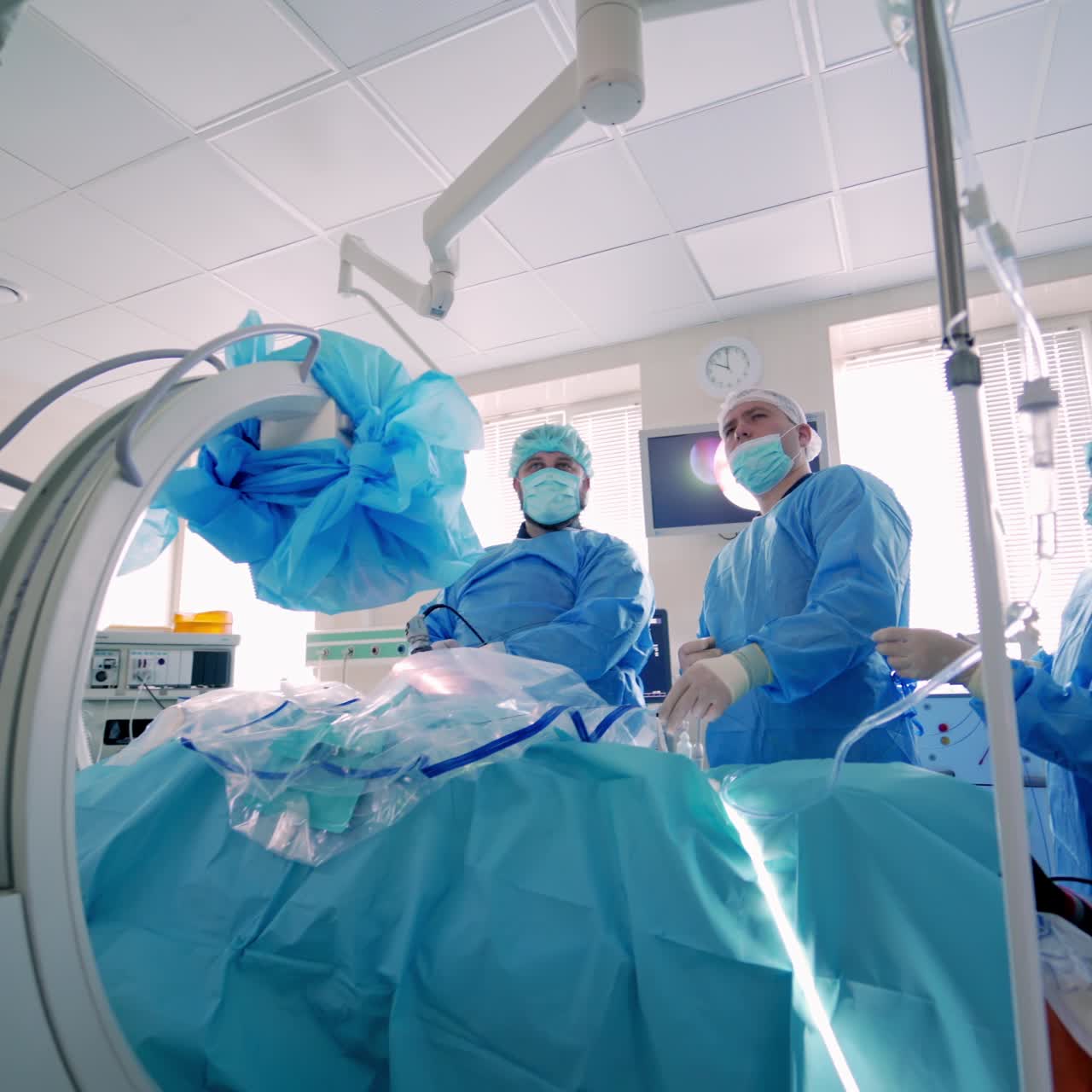 Medical procedure in emergency room. Surgical team performing surgery in modern operation theater