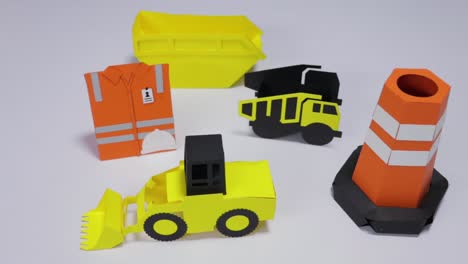 assortment of cardboard-made construction gear set on a white background