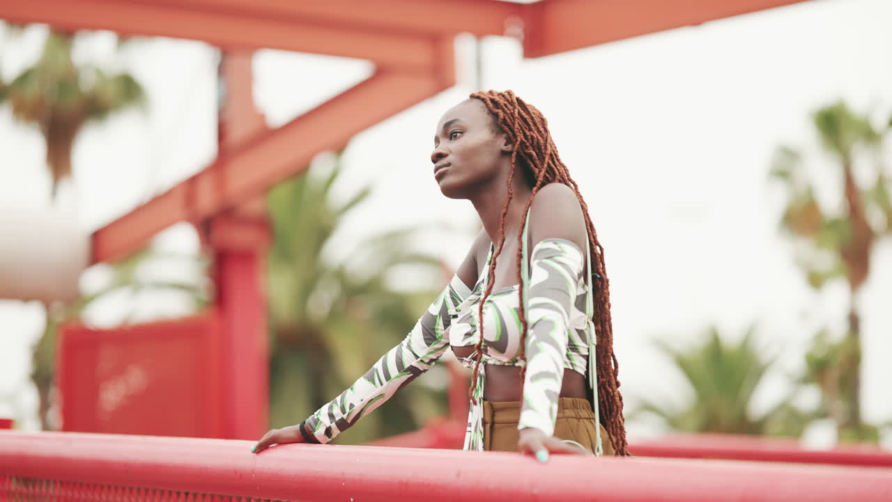Woman with Braids Posing on Red Bridge