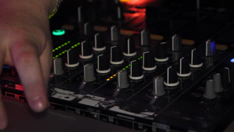 handheld-shot-of-dj-playing-on-a-mixer