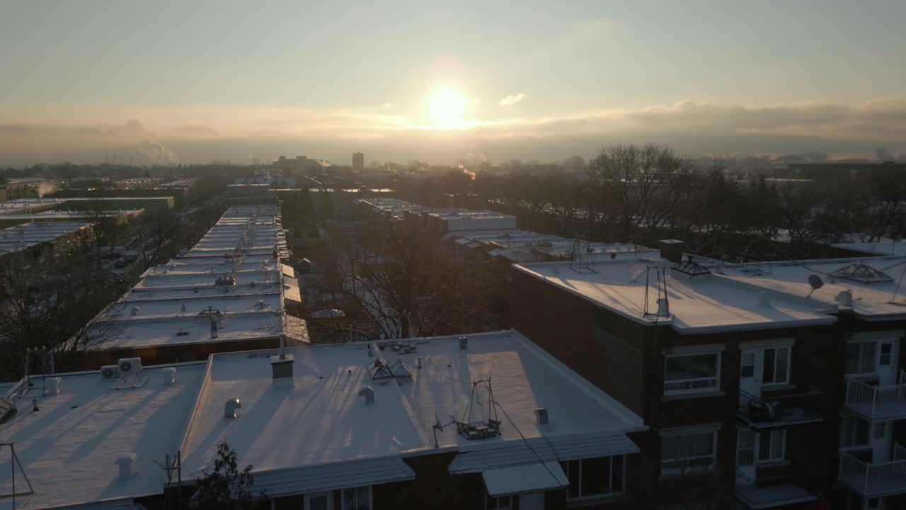 Winter cityscape of Vieux Rosemont with Olympic Stadium visible on horizon at soft sunset light, panoramic establishing Montreal Canada