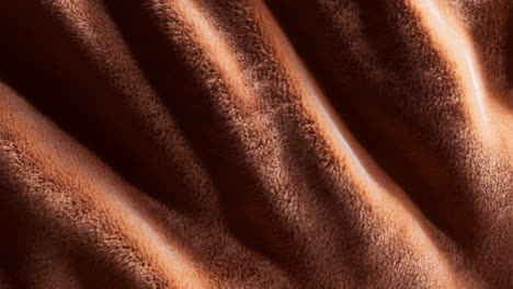 close-up of brown furry fabric texture with folds