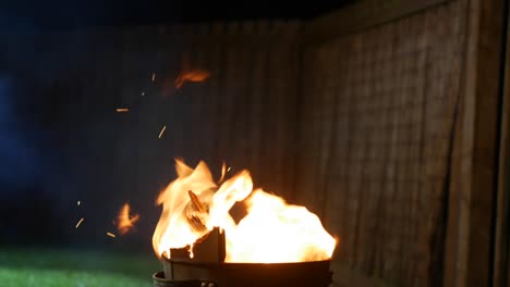 cautiously adding wood to fire