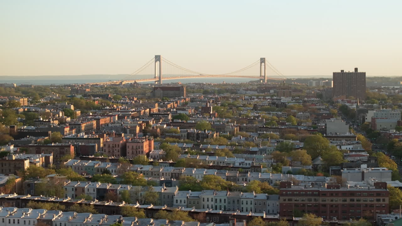Aerial view of rush hour traffic on Brooklyn's Belt Parkway. Shot at sunset in Bay Ridge with the Verrazzano Bridge in the background.