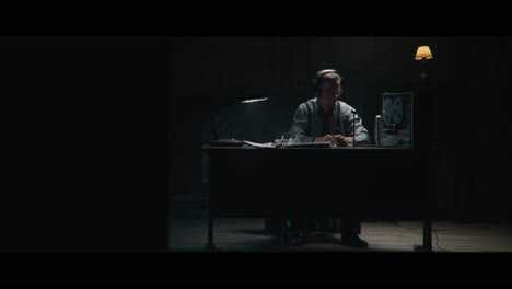 an intelligence officer listens to the wiretap recordings