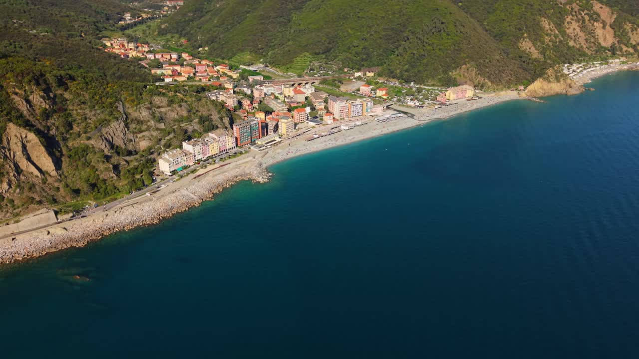 Beautiful coastal town in Italy with clear water and colorful buildings along the beach