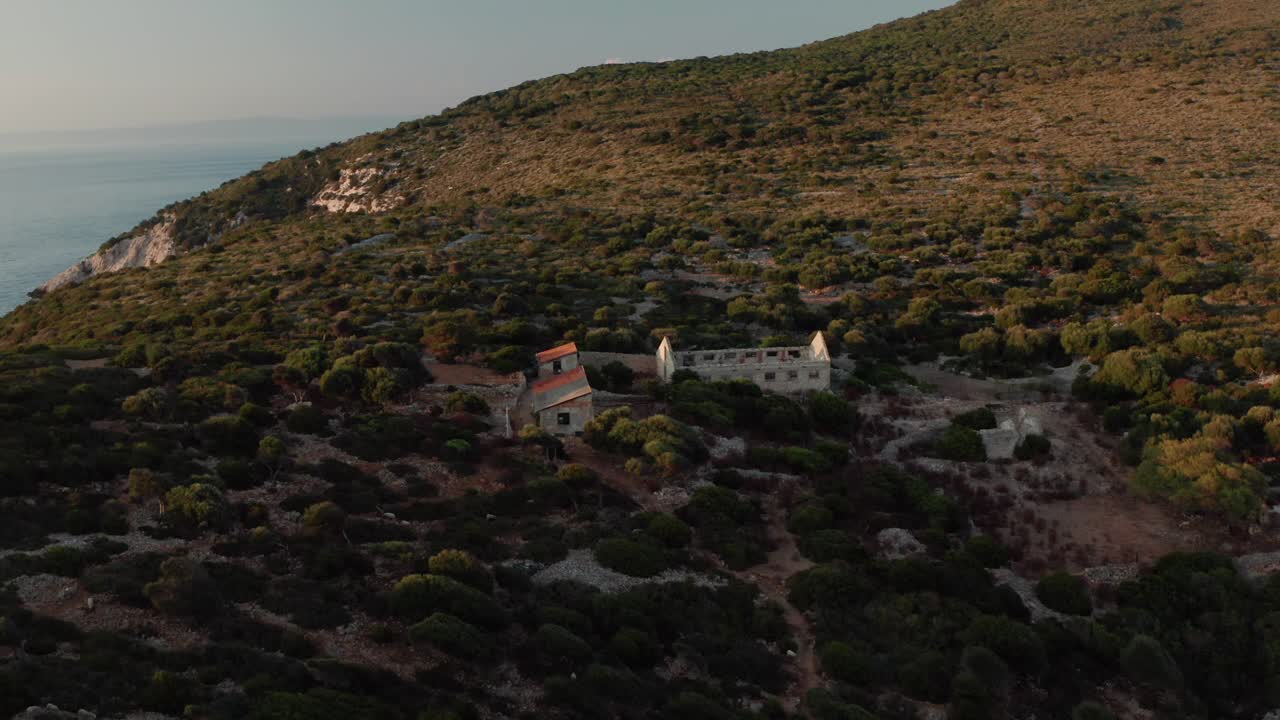 Sušac, Adriatic Sea, Croatia - Remnants of Old Buildings and Structures Situated on the Rocky Forested Island - Orbit Drone Shot