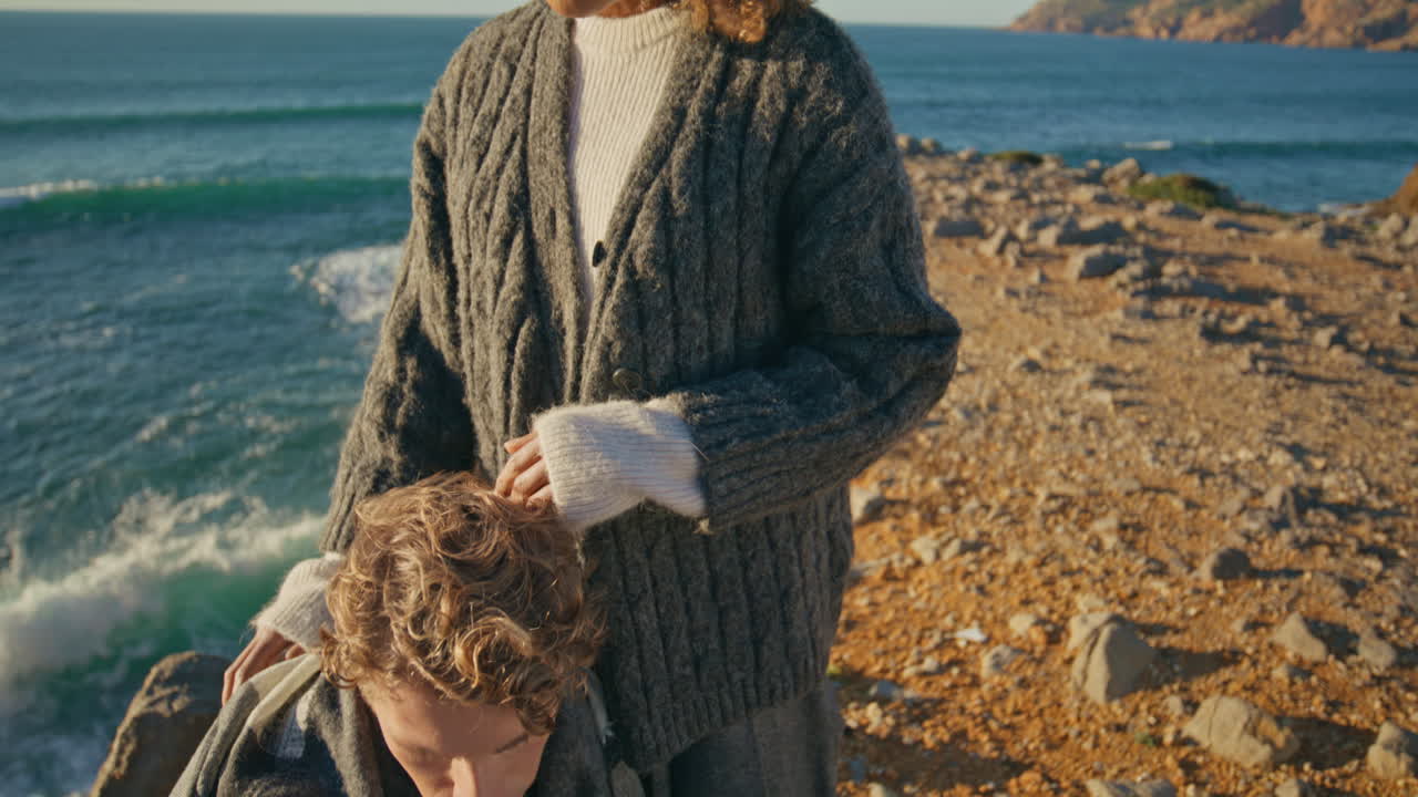 Tender girl caressing man at sea horizon closeup. Loving couple romantic date