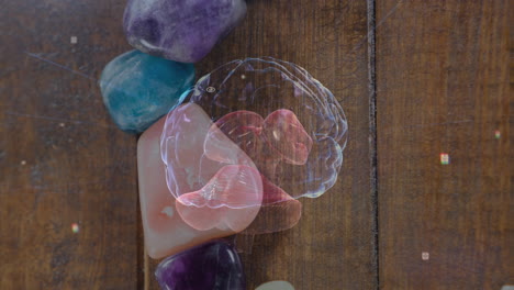 digital brain hologram hovering over polished stones on wooden plank, showing floating ui elements