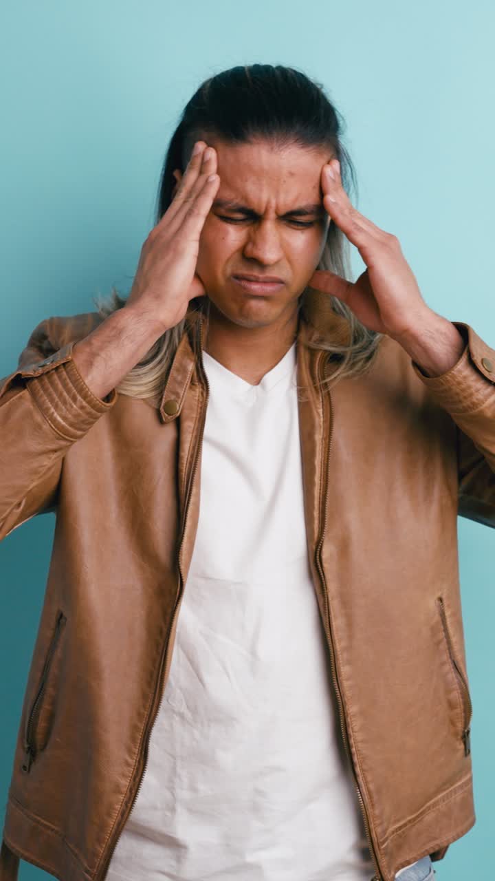 Man Suffering from Headache or Migraine in Studio