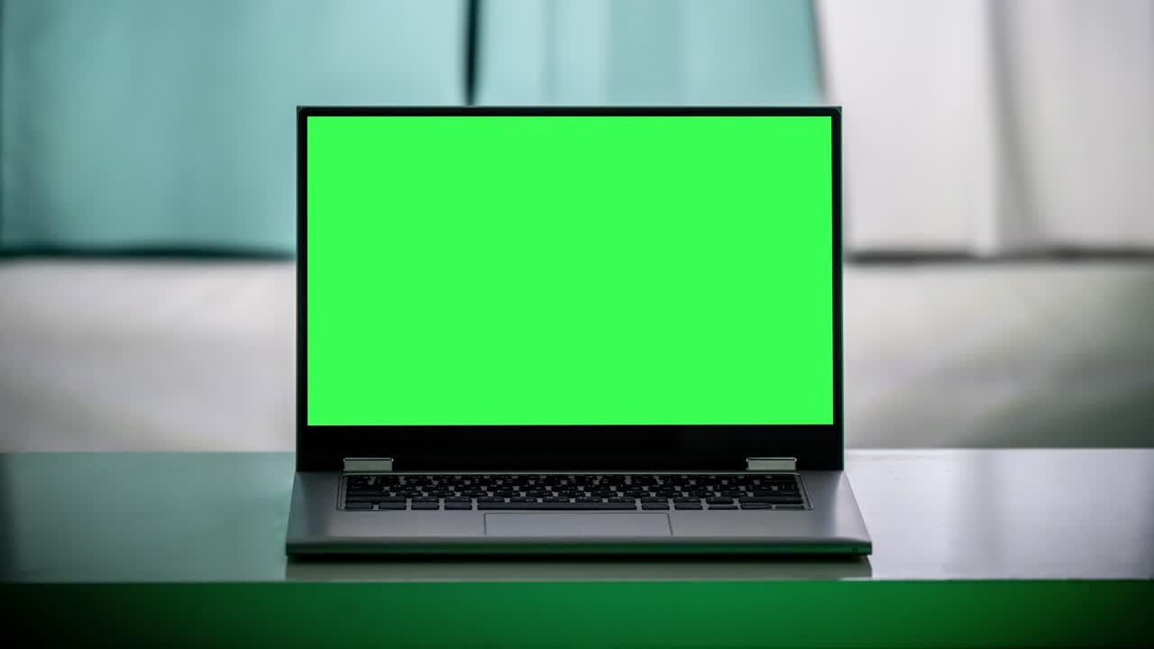 Working in the evening. Laptop with green screen. Zoom in. Template for keying