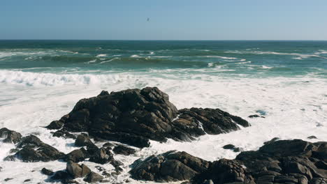 foamy ocean waves and rock formations at the beach in west coast national park, south africa - static shot