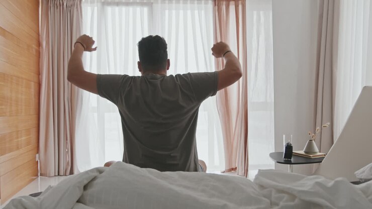 Latin Man Stretching In Bed After Sleep