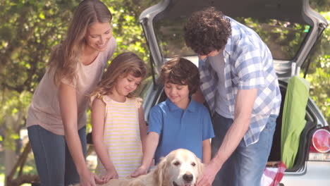 family with dog in the park