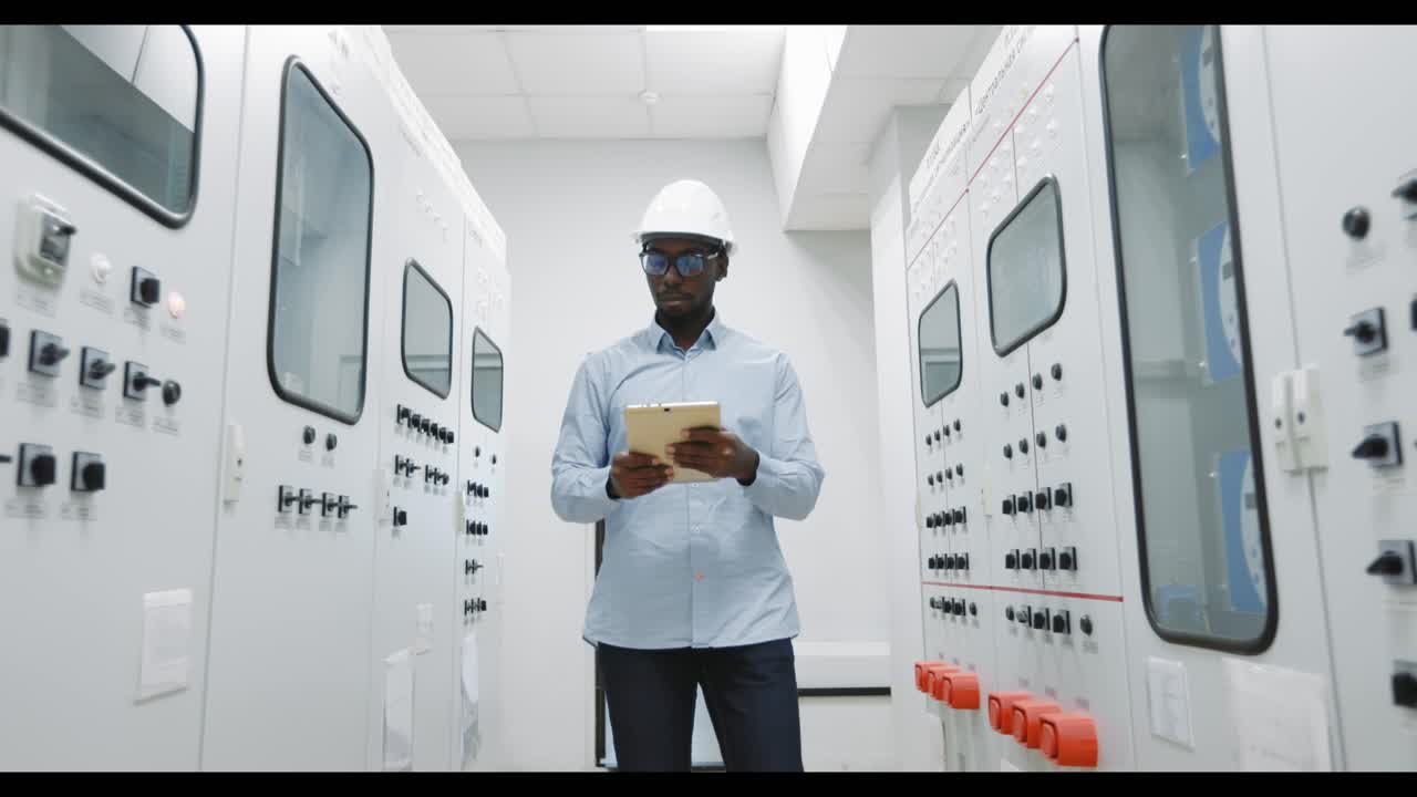 Engineer Working on Control Panel in Power Plant