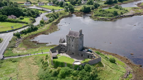 aerial reverse shot of dunguaire castle and surrounding area in county galway, ireland